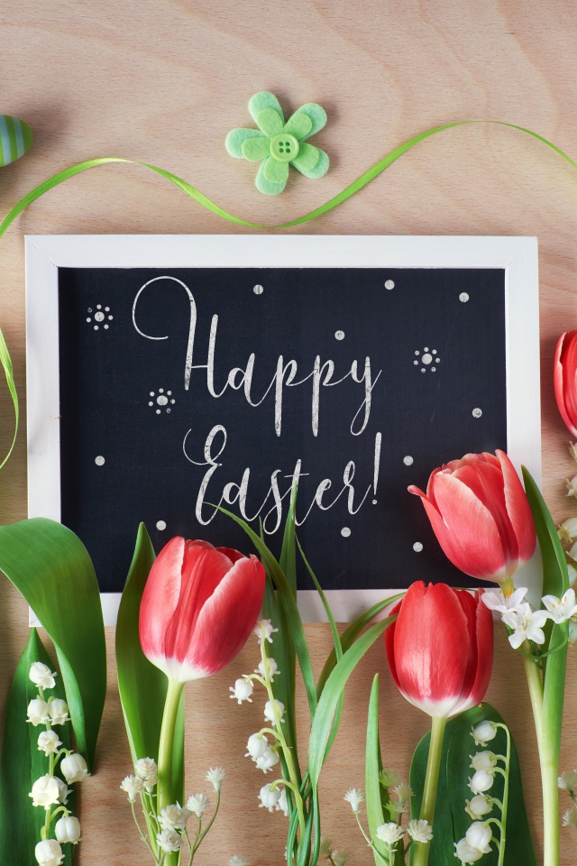 Надпись Счастливой Пасхи на столе с букетом тюльпанов