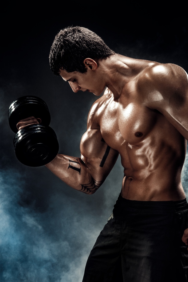 Inflated man with dumbbell in hand in smoke