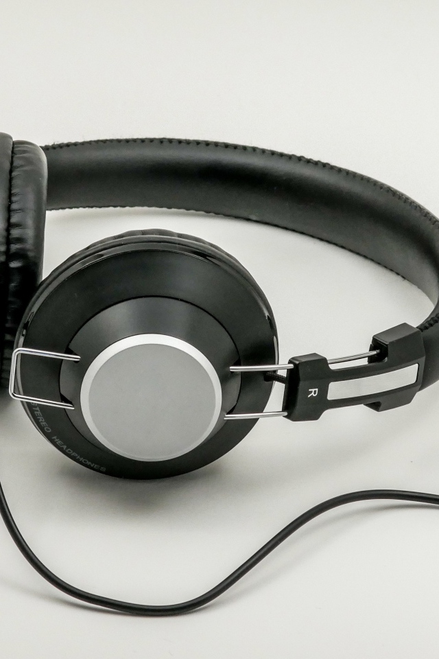 Big black headphones on gray background