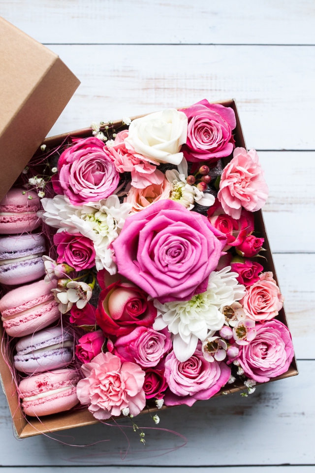 Box with fresh flowers and dessert for a gift