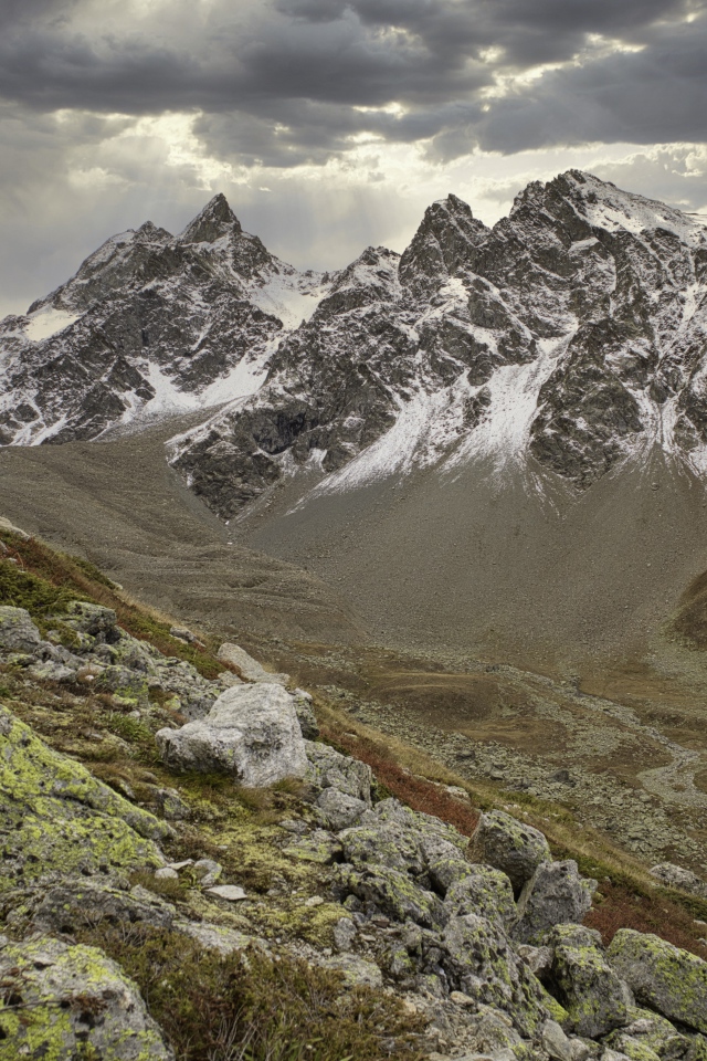 Высохшая река в горах под грозовым небом