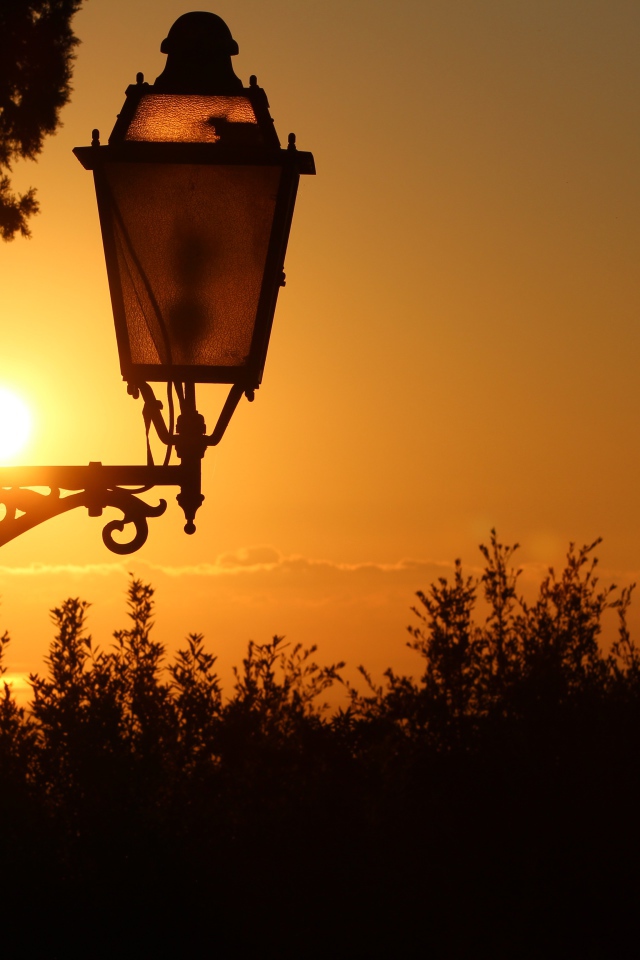 Фонарь на дома на закате солнца