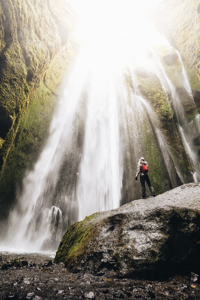Быстрый водопад стекает между скал 