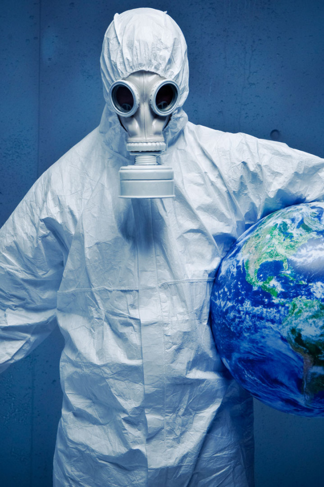 A man in a white protective suit saves the planet from a pandemic coronavirus covid-19