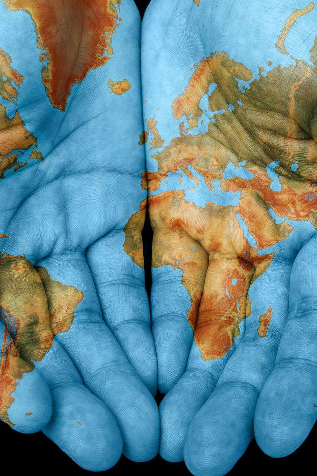 Hands with world map on black background