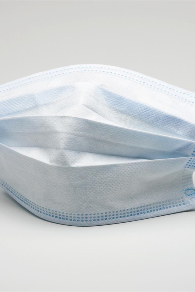 Медицинская маска защита от коронавирус covid-19 на сером фоне