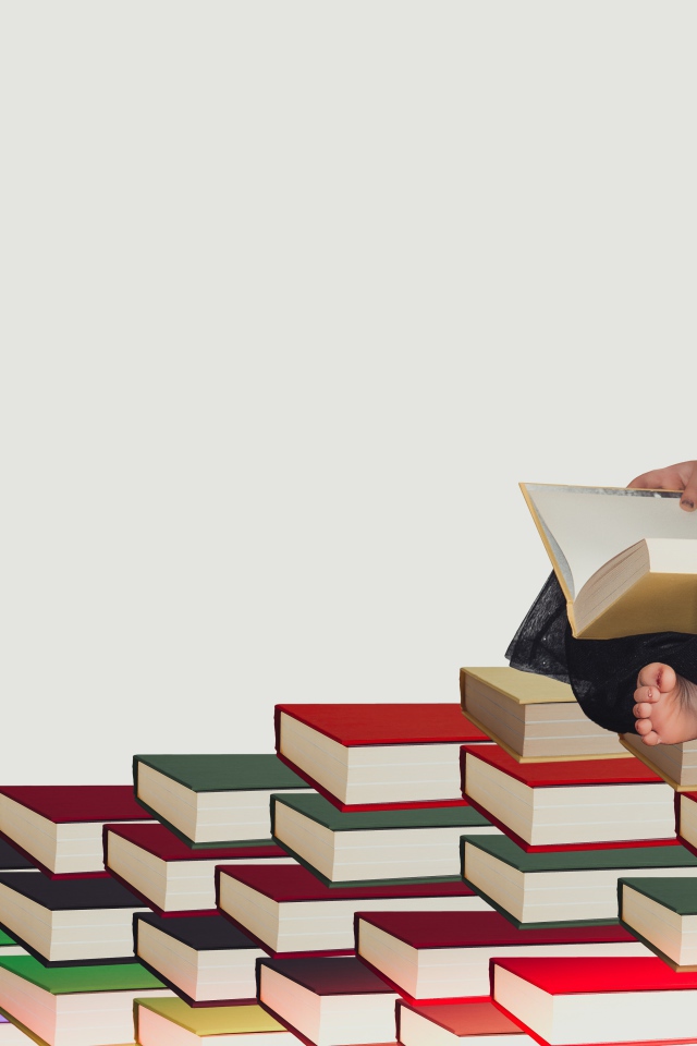 Маленькая девочка сидит на горе книг 