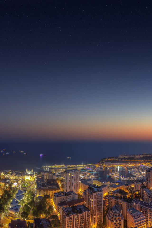 View of the night city of Monaco under a blue sky