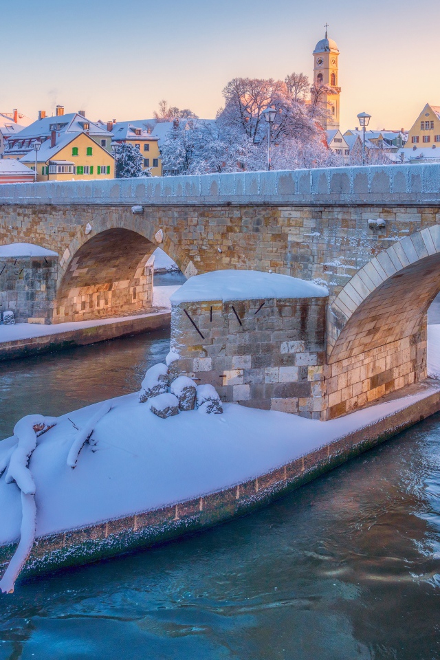 Stone bridge over Danube river in winter, Germany