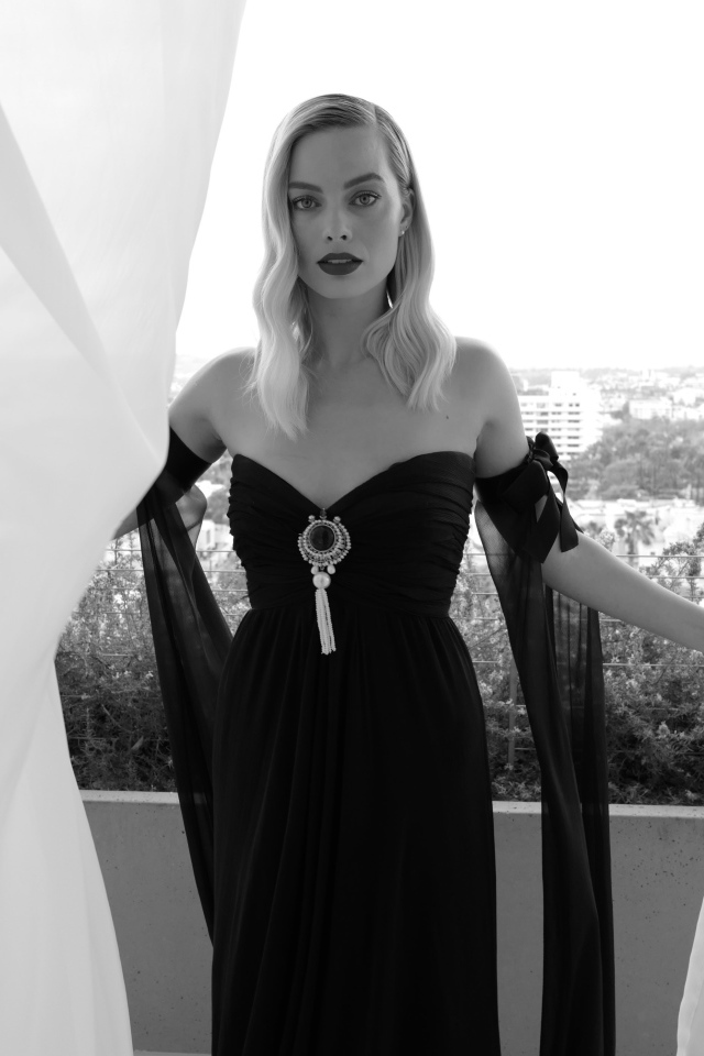 Актриса Марго Робби в черном платье на балконе 