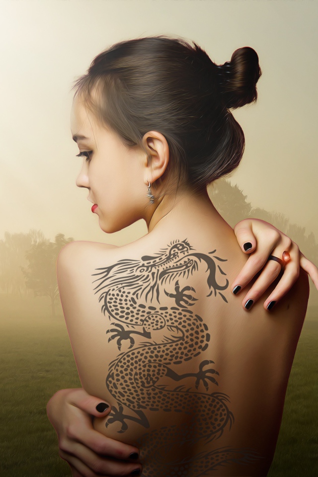Beautiful girl with a dragon tattoo on her back