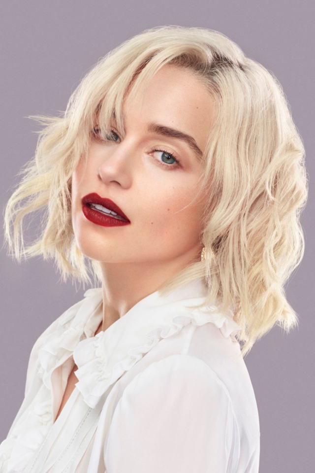 Эффектная блондинка, актриса Эмилия Кларк на сером фоне