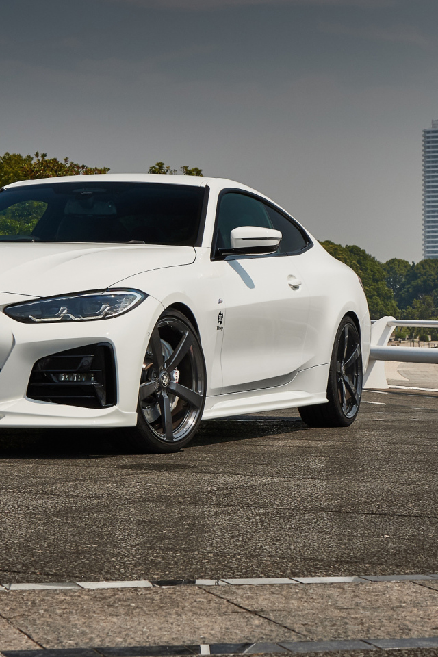 Белый автомобиль BMW 4 Series Coupé M Sport Package 2021 года у города