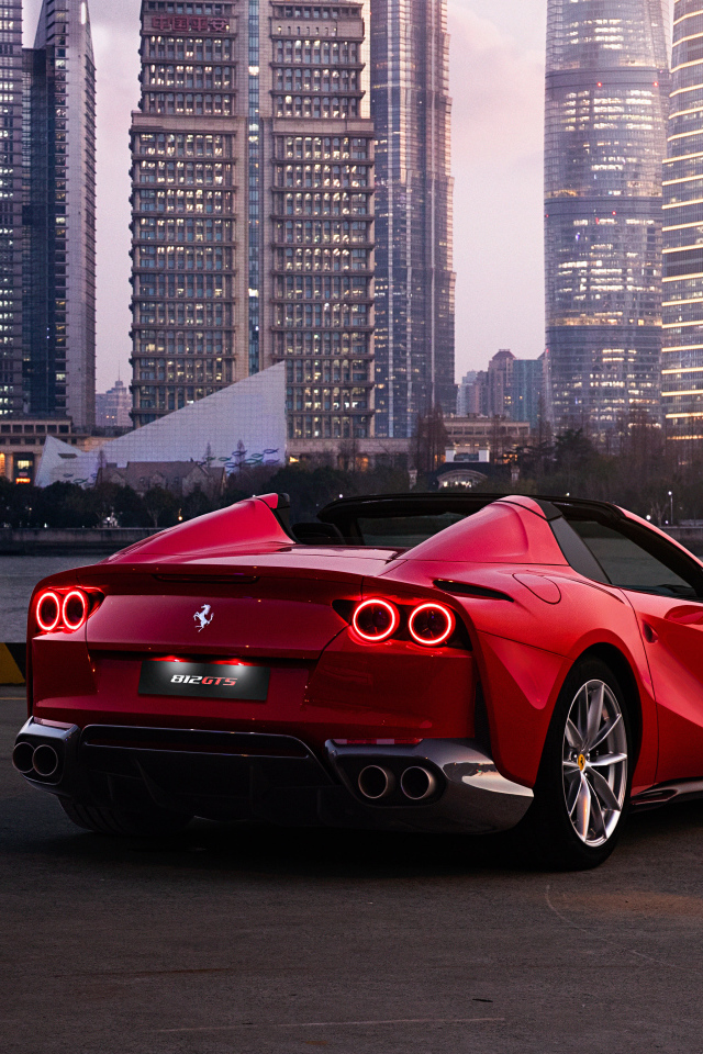 Автомобиль  Ferrari 812 GTS вид сзади на фоне города