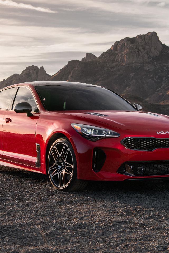 Красный автомобиль  Kia Stinger GT, 2022 года в горах