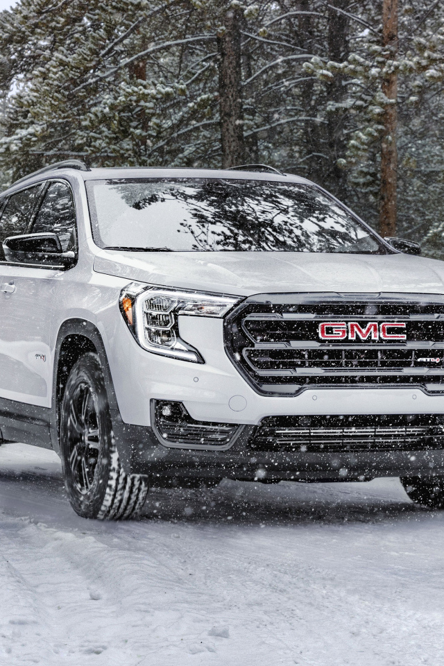Большой белый внедорожник GMC Terrain AT4, 2022 года на снегу