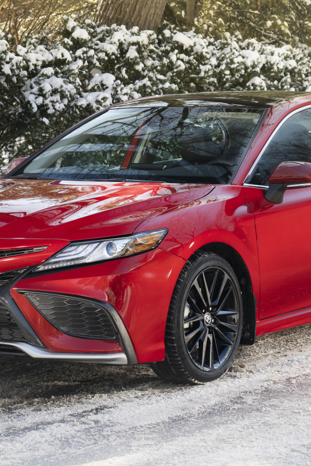 Красный автомобиль  Toyota Camry XSE AWD, 2021 года зимой