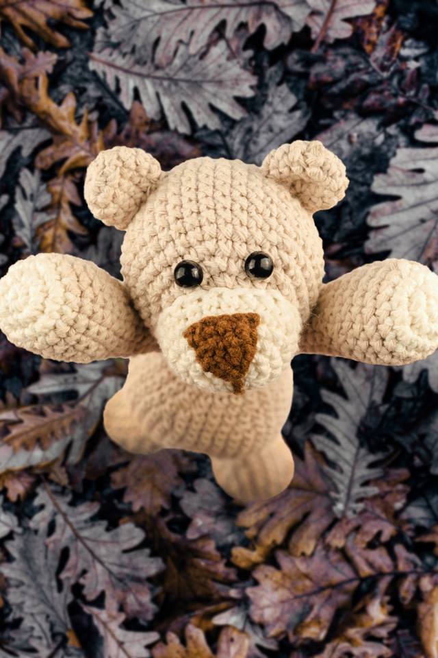 Вязаная игрушка медвежонок на листве
