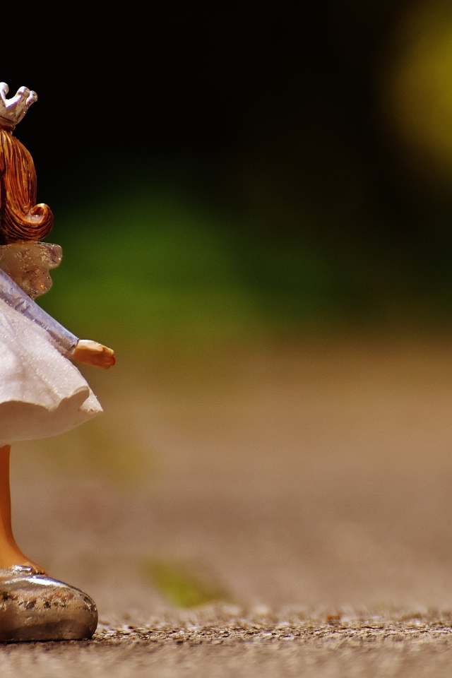 Статуэтка принцесса стоит на асфальте 