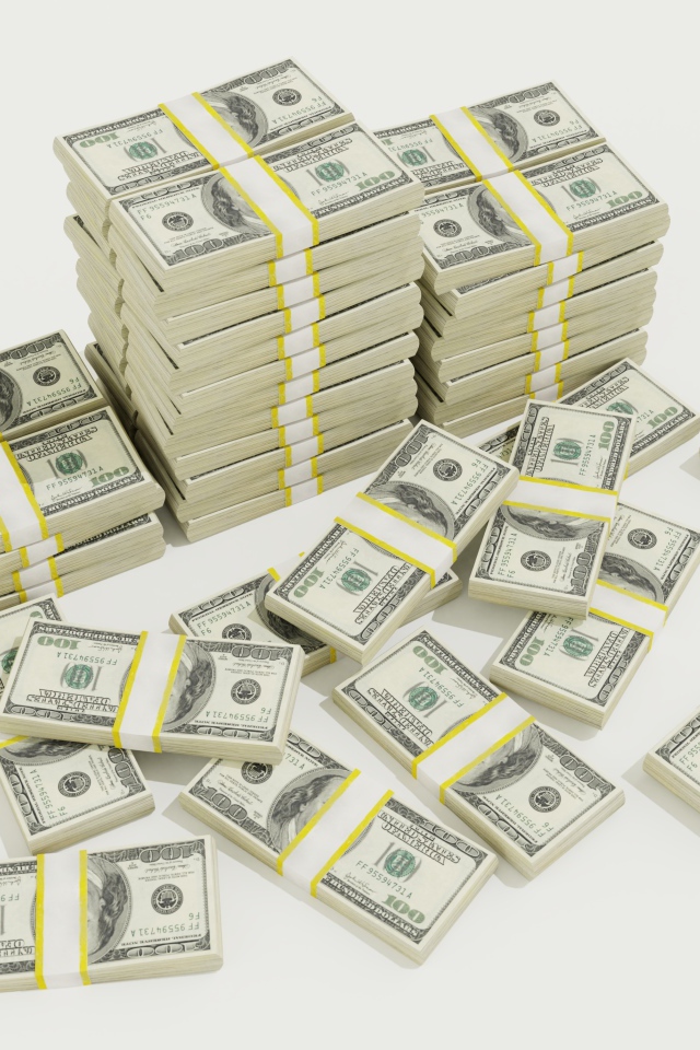 Пачки долларов на белом фоне