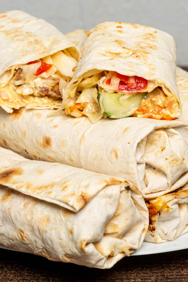 Аппетитная шаурма в лаваше на столе 