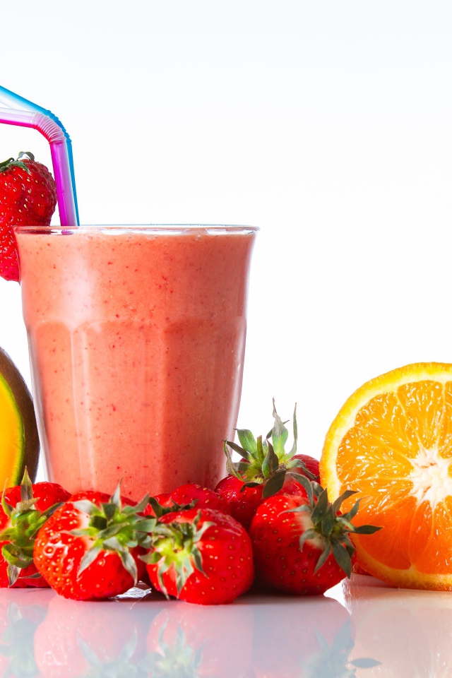 Ripe mango with strawberry and orange on a smoothie table