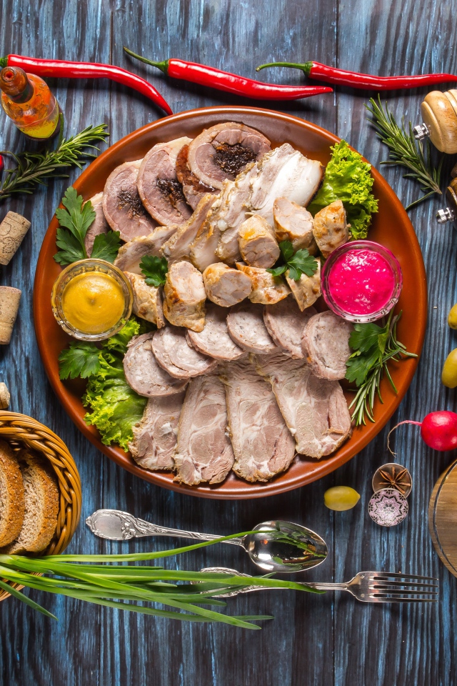 Appetizing cold cuts on the table with spices and bread