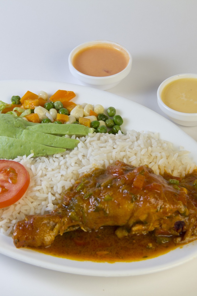 Rice with chicken and vegetables on the table with sauce