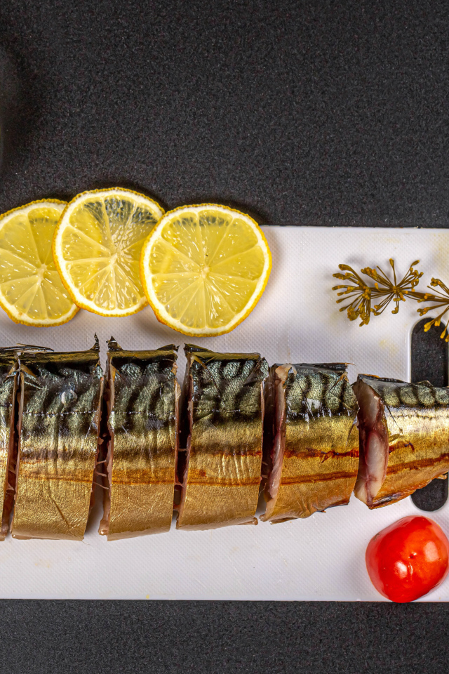 Appetizing mackerel on a board with lemon and butter