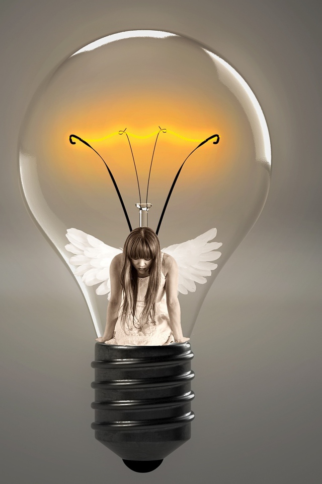 Angel girl in incandescent lamp on gray background