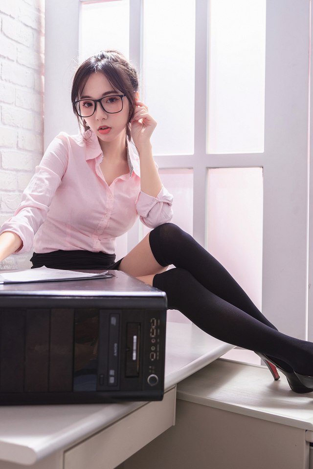 Девушка азиатка в черных чулках с системным блоком