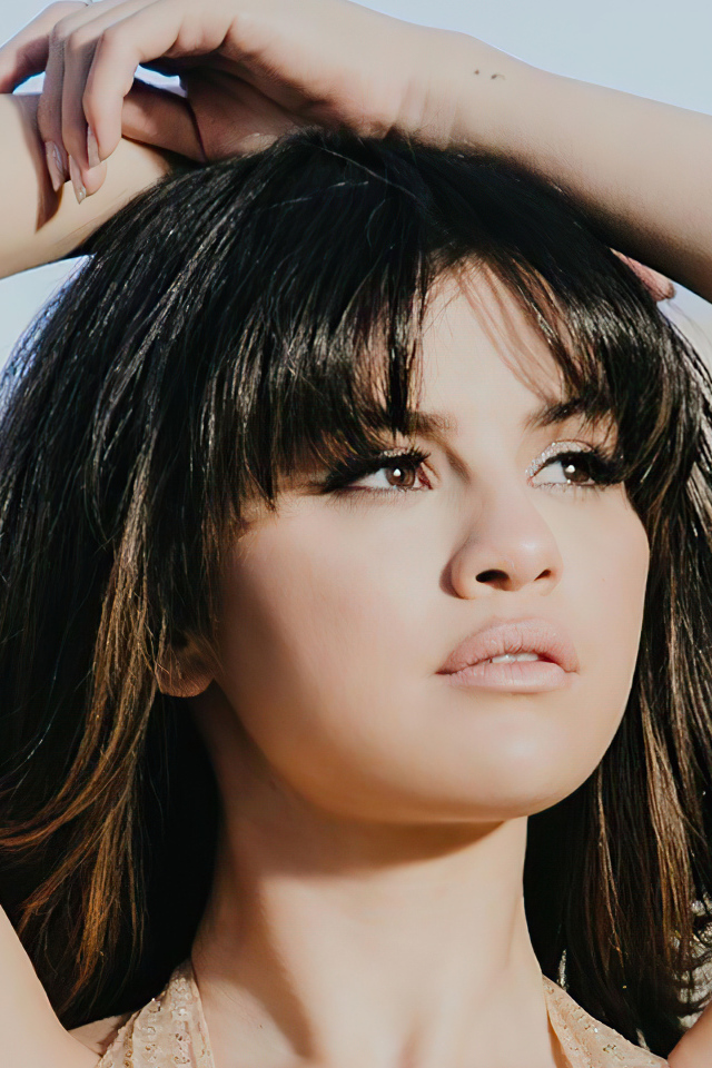 American singer Selena Gomez in raised arms