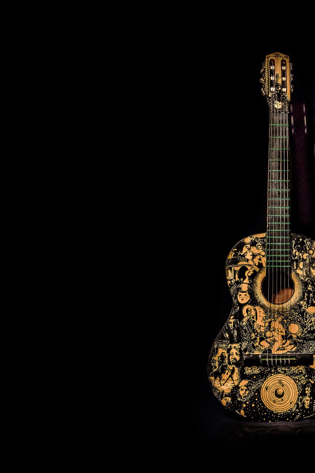 Красивая гитара с рисунком на черном фоне