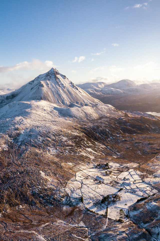 Вид на высокие заснеженные горы в лучах солнца