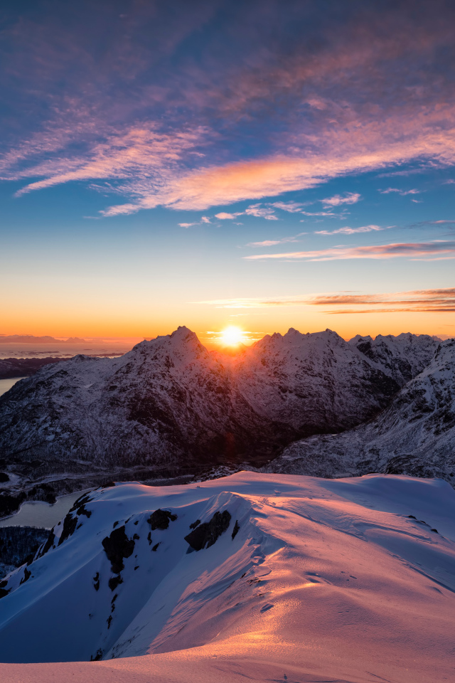 Восход яркого солнца над заснеженными горами, Норвегия
