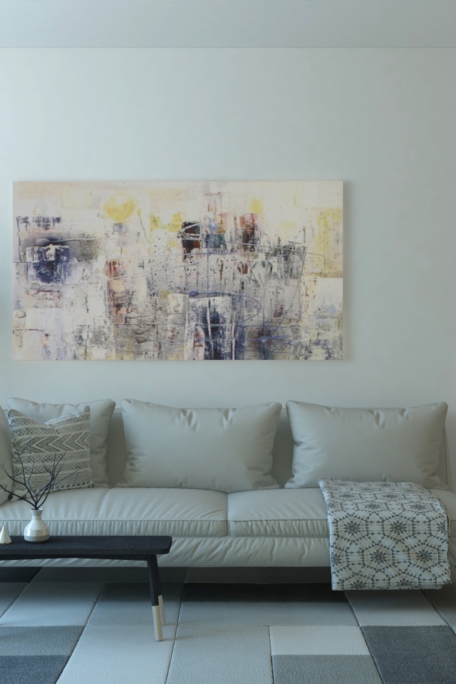 Кожаный диван стоит у стены с картиной