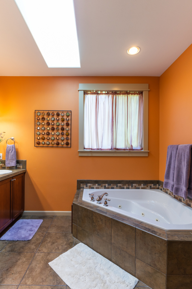 Большая ванная комната с оранжевыми стенами 