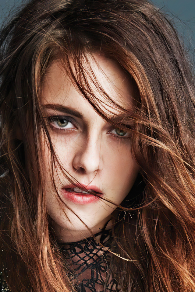 The face of actress Kristen Stewart on a gray background