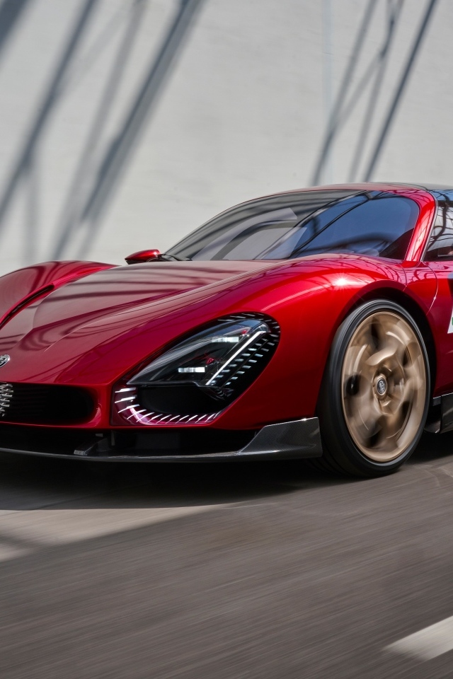 Красный  Alfa Romeo 33 Stradale 2024 года на фоне серой стены