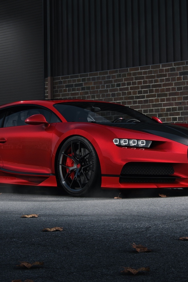Красный автомобиль Bugatti Chiron CGI у кирпичной стены