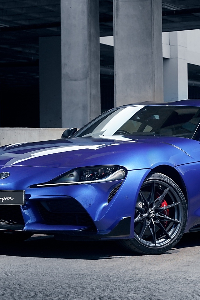 Синий автомобиль Toyota GR Supra 3.0 MT 2023 года у серого здания