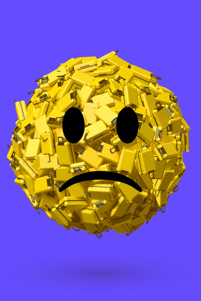 Грустный смайлик из чемоданов на синем фоне