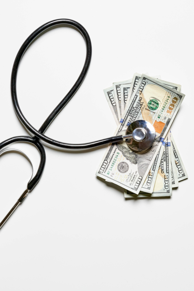 Stethoscope with dollars on a white background