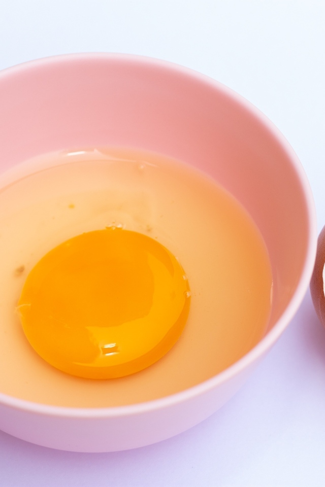 Разбитое яйцо на столе со скорлупой