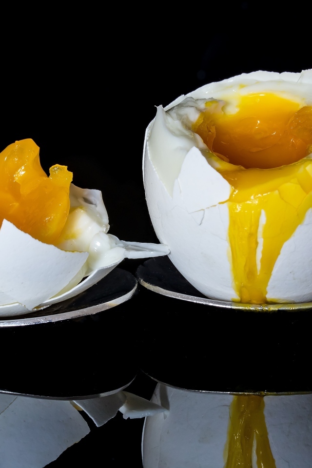 Яйцо с жидким желтком на черном фоне