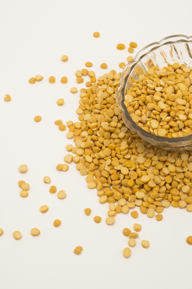 Чечевица рассыпана на белом фоне