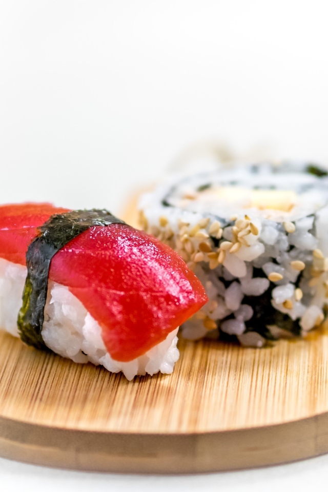 Суши на доске на белом фоне