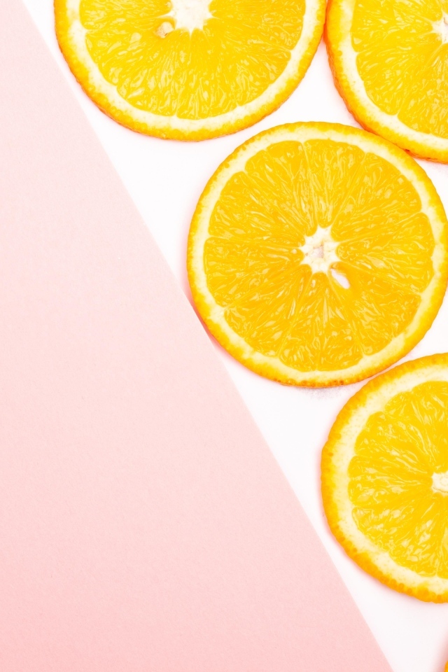 Кружочки апельсина на розовом фоне