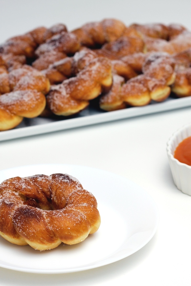 Сладкие пончики в сахарной пудре на столе