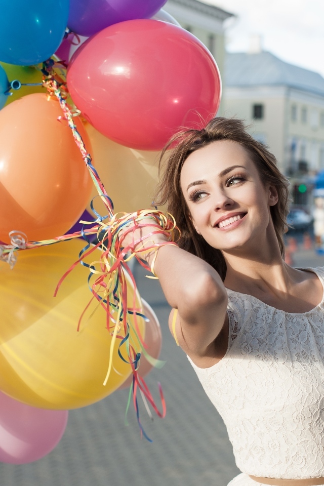 Улыбающаяся девушка с воздушными шариками